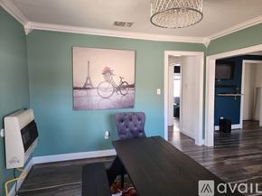 Keithville house for rent - A dining room with a purple chair and a painting of the Eiffel Tower.
