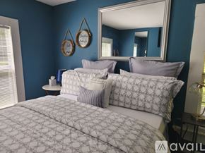 Keithville house for rent - A bedroom with a large bed and a mirror on the wall.