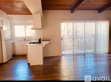 Thousand Oaks apartment for rent - A kitchen with white cabinets and a black countertop.