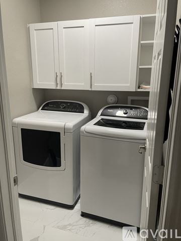 Homestead house for rent - A white dishwasher and dryer are in a small kitchen.