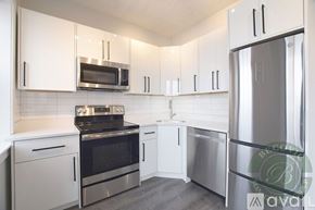 Chicago apartment for rent - A kitchen with white cabinets and stainless steel appliances.