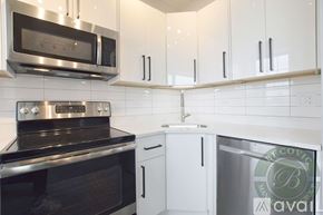 Chicago apartment for rent - A kitchen with white cabinets and a stainless steel oven.