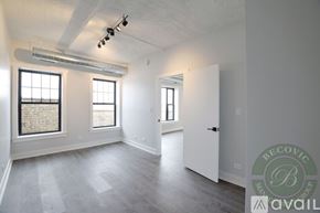 Chicago apartment for rent - A spacious room with a window and a door.