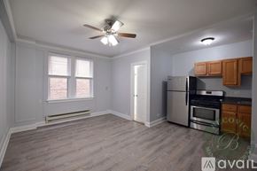 Chicago apartment for rent - A kitchen with a refrigerator, oven, and microwave.