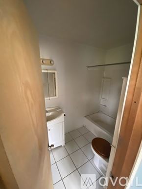 Finleyville house for rent - A bathroom with a toilet, sink, and bathtub.
