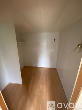 Finleyville house for rent - A room with wooden floors and white walls.