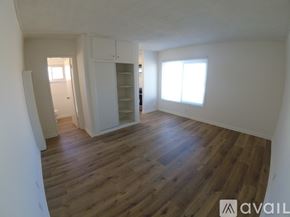 Hawthorne apartment for rent - A room with wooden flooring and white walls.