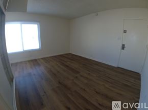 Hawthorne apartment for rent - A room with wooden flooring and a white door.