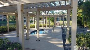 West Palm Beach condo for rent - A pool area with a pergola and a pool table.
