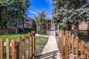 Denver apartment for rent - A wooden fence leads to a house entrance.