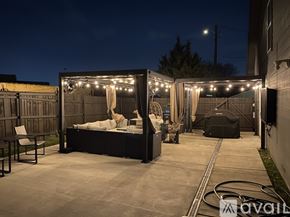 Fort Worth house for rent - A cozy outdoor space with a bed and lights strung up.