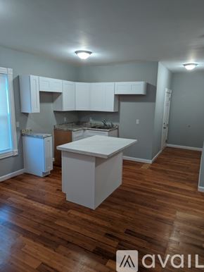 Fall River apartment for rent - A kitchen with white cabinets and a white island.