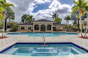 West Palm Beach condo for rent - A house with a pool in front of it.