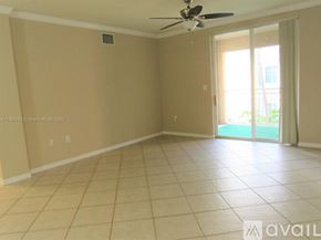 West Palm Beach condo for rent - A room with beige walls and a ceiling fan.