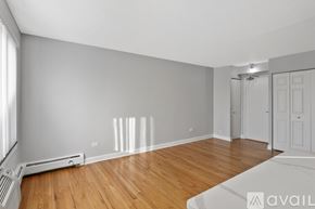 Chicago apartment for rent - A room with wooden floors and white walls.