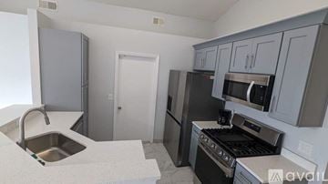 Orlando house for rent - A kitchen with a sink, stove, and refrigerator.
