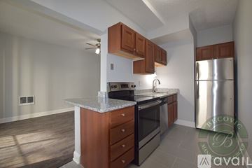 Chicago apartment for rent - A kitchen with wooden cabinets and a stainless steel refrigerator.