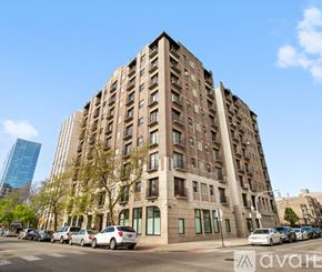 Chicago apartment for rent - A large, old building with many windows is in the foreground of the image.