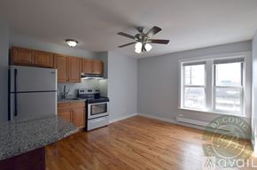 Chicago apartment for rent - A kitchen with a refrigerator, oven, and a ceiling fan.