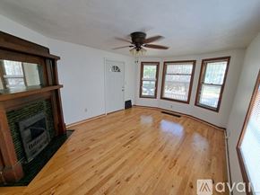 Kalamazoo apartment for rent - A room with wooden floors and a fireplace.