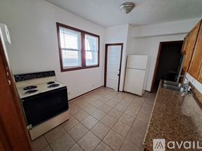 Kalamazoo apartment for rent - A kitchen with a stove, sink, and refrigerator.