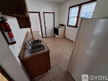 Kalamazoo apartment for rent - A kitchen with a sink and a refrigerator.