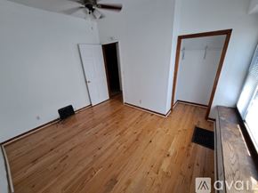 Kalamazoo apartment for rent - A room with wooden flooring and a ceiling fan.