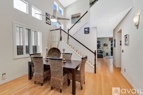 Los Angeles house for rent - A dining room with a wooden table and chairs is available for rent.