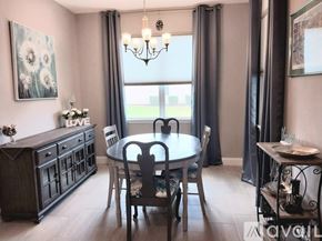 Bradenton house for rent - A dining room with a table set for four.