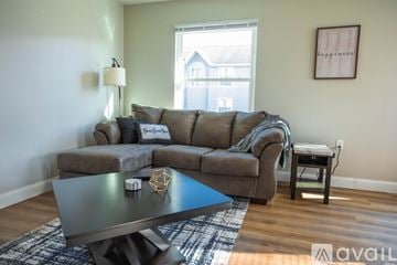 Morgantown apartment for rent - A living room with a grey sofa and a blue coffee table.