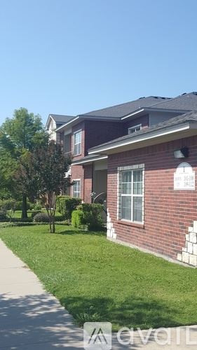 Gatesville apartment for rent - A house with a red brick exterior and a white window.