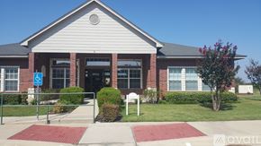 Gatesville apartment for rent - A building with a red carpet in front and a sign that says "available".
