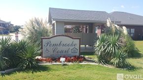 Gatesville apartment for rent - A sign for Pembrooke Court is in front of a building.