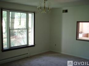 Ellicott City house for rent - A room with a window and a chandelier.