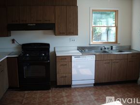 Ellicott City house for rent - A kitchen with a black oven and white dishwasher.