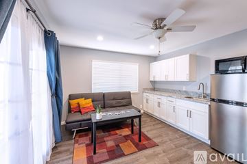 Wailuku house for rent - A living room with a grey couch and a coffee table.
