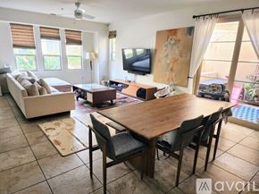 Chula Vista apartment for rent - A living room with a television, a couch, a table, and chairs.