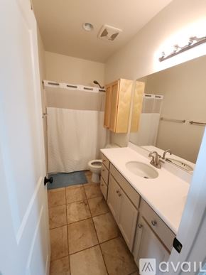 Chula Vista apartment for rent - A pool with chairs around it and palm trees in the background.