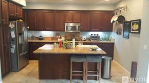 Chula Vista apartment for rent - A kitchen with brown cabinets and a granite countertop.