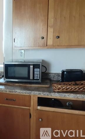 New Orleans apartment for rent - A kitchen with wooden cabinets and a microwave on the counter.