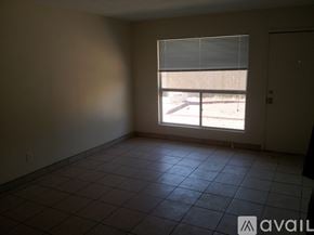 Phoenix apartment for rent - A room with a tiled floor and a window with blinds.