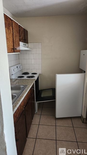 Phoenix apartment for rent - A kitchen with a white fridge, white stove and white oven.
