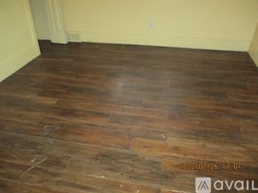 Detroit apartment for rent - A room with wooden flooring and a wall in the background.