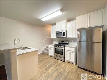 Edmond house for rent - A kitchen with white cabinets and stainless steel appliances.