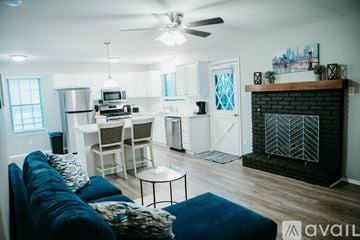 Jacksonville house for rent - A living room with a blue couch and a fireplace.