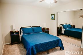 Jacksonville house for rent - A bedroom with a blue bedspread and a bed with a blue cover.