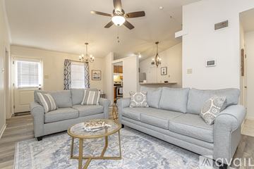 Little Rock house for rent - A living room with a grey couch and a coffee table.