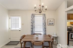 Little Rock house for rent - A dining room with a wooden table and chairs.
