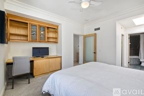 Oceanside apartment for rent - A bedroom with a bed, dresser, and ceiling fan.