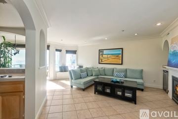 Oceanside apartment for rent - A living room with a grey couch and a painting on the wall.